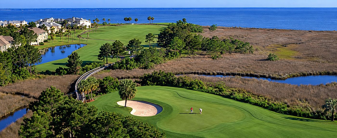 Aerial view of a green beside marsh and open water